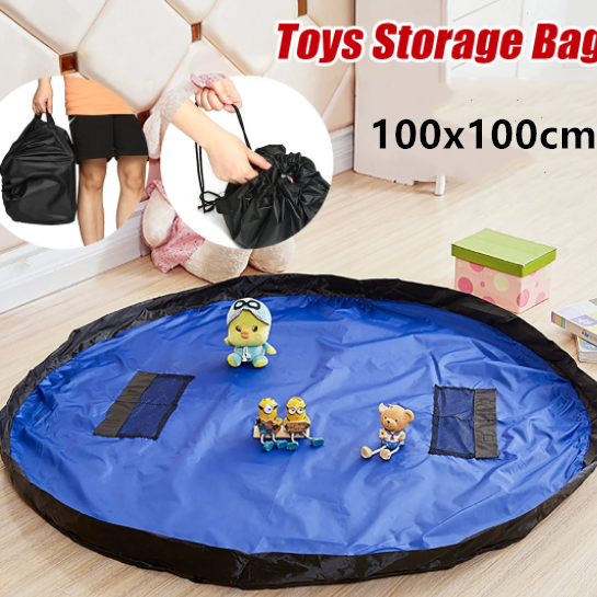 Blue toys storage bag with cartoon characters on a wooden floor, surrounded by small toys.