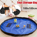 Blue toys storage bag with cartoon characters on a wooden floor, surrounded by small toys.