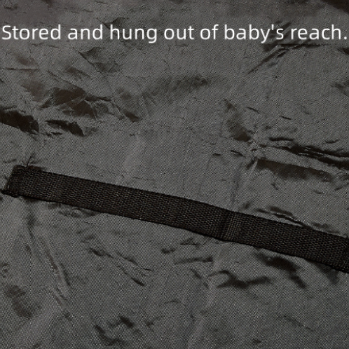 Black strap on a textured gray surface with text indicating it is stored out of baby's reach.
