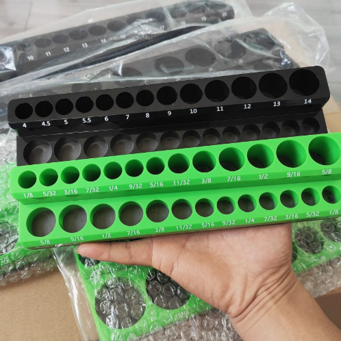 Green and black hole increment chart held by a hand with packaging in the background