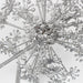 Close-up of a metallic snowflake ornament on a light gray background