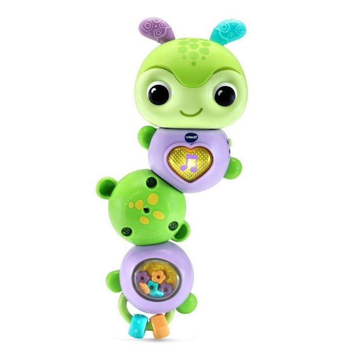 Green and purple toy with a smiling face on a white background