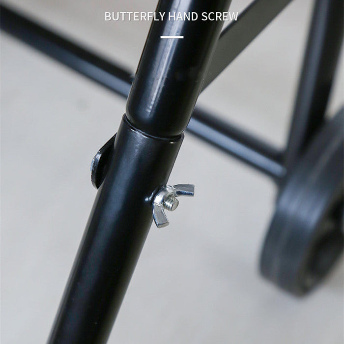 Butterfly hand screw on a black metal frame with a blurred background