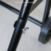 Butterfly hand screw on a black metal frame with a blurred background