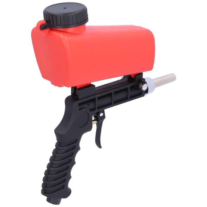 Red spray gun with black handle on a white background