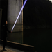 Person holding a flashligt in a dark, industrial setting