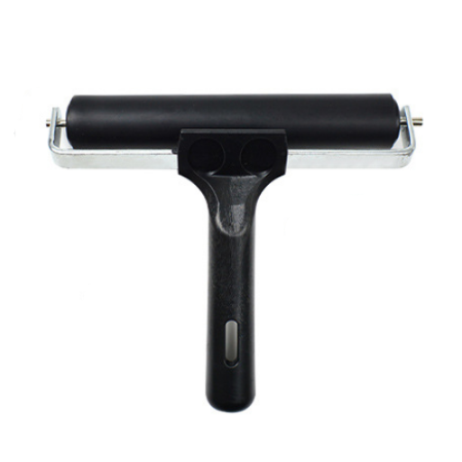 Black roller tool with a metallic handle on a white background
