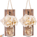 Two hanging wall sconces with floral arrangements and string lights on a white background