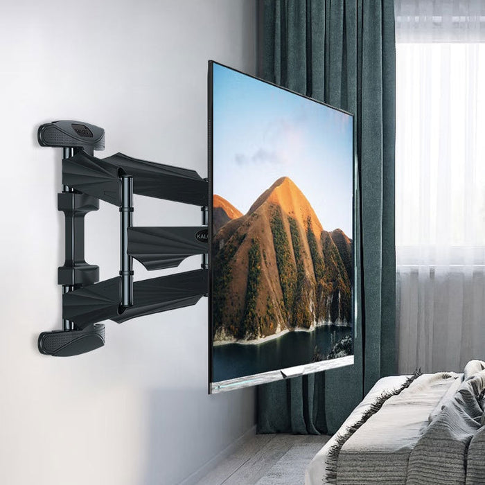 TV mounted on a wall with a scenic display, in a room with a sofa and curtains.