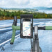 Bicycle handlebar with a waterproof phone holder on a road with a scenic background