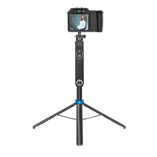 Camera on a tripod with a smartphone attached, on a white background