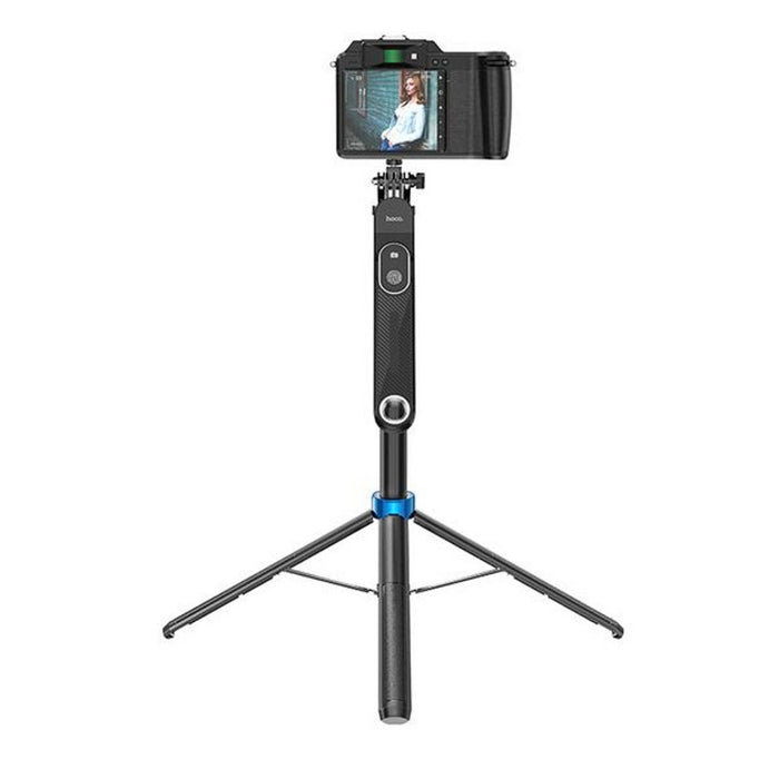 Camera on a tripod with a smartphone attached, on a white background