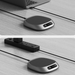 Two views of a small electronic device on a wooden surface with a laptop in the background.