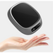 Gray USB Coffee Mug Warmer hovering above a hand on a white background