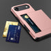 Phone case with card slots holding two credit cards on a dark background