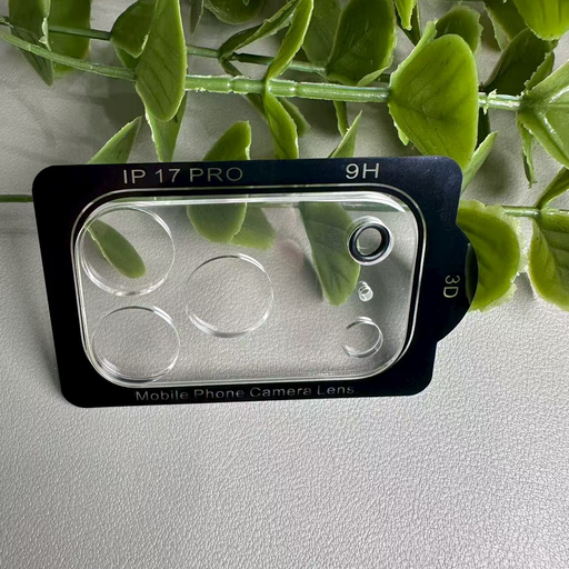 Phone camera lens protector with 'IP 17 Pro' and '9H' text, surrounded by green leaves on a light gray background