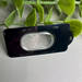 Phone camera lens protector with text on a light gray background