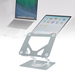 An adjustable height laptop stand with a 360° rotating base, made of silver aluminum alloy, shown holding a laptop and a tablet.