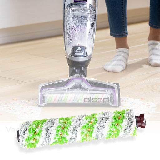 A set of four Bissell brush rolls for vacuums, featuring a green and white Christmas-themed design, displayed next to a vacuum cleaner.