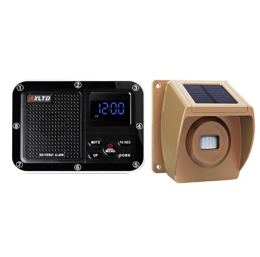 A two-piece solar driveway alarm system, with a black base and a gold-colored sensor.