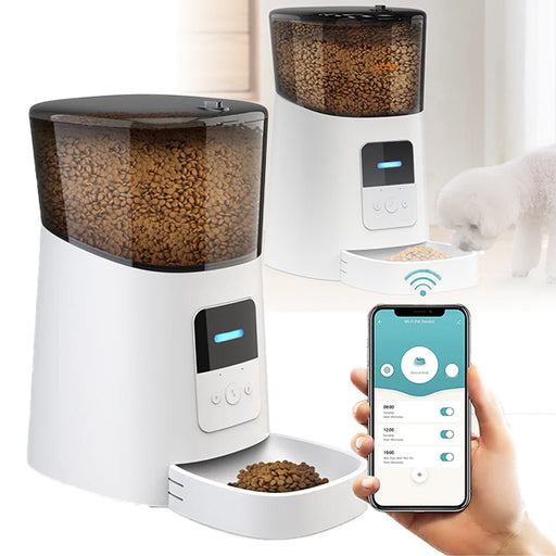 A white automatic pet feeder with a clear food storage container at the top and a smartphone displaying the app interface for controlling the feeder in the foreground.