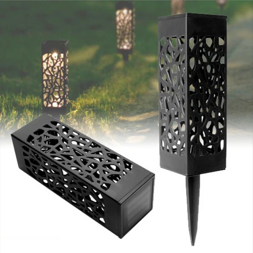 A set of black solar powered garden lawn lights with a geometric pattern, installed in a garden setting to illuminate the pathway.
