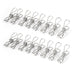 
A simple product image showing sixteen stainless steel mini spring clips (or clothes pegs) arranged in two parallel rows of eight, viewed at a slight angle on a white surface.