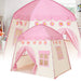 A pink children's play tent designed to resemble a castle with decorative details and a flowing pink curtain.