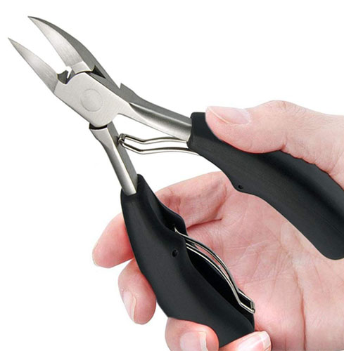 A person holding heavy duty toe nail clippers with stainless steel blades and black rubber handles.