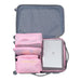 
An open suitcase shows a set of pink travel packing cubes organized on one side, leaving space for a silver laptop or tablet. The bags consist of two small mesh cubes and two flat "LAUNDRY POUCH" bags stacked vertically, demonstrating the efficient use of the luggage organizer set.